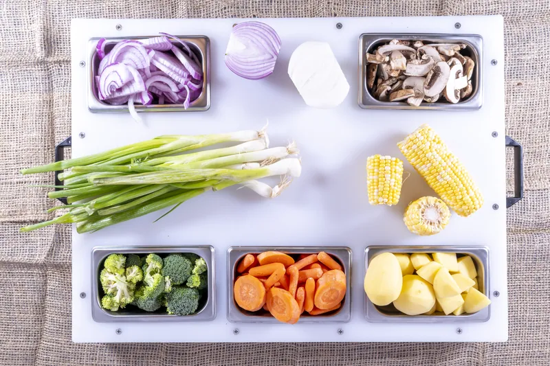 Six pans of chopped vegetables organized on one DisplayPrep board